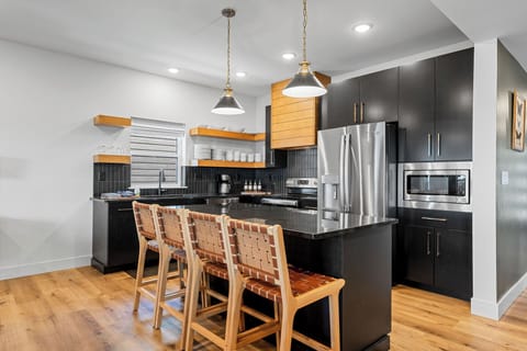 The kitchen includes full-size appliances, a 12-cup coffee maker, and a fully stocked coffee bar—everything you need for a great start to the day.