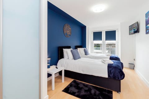 Comfortable room with two single beds, offering a restful space for a peaceful night's sleep during your stay.