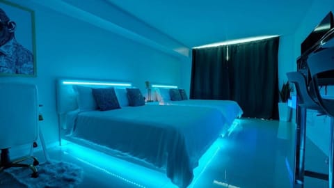 Embrace the serenity of luxury: Two queen-sized beds, softly lit by LED, beckoning you to a night of tranquil comfort in a hotel-grade haven.