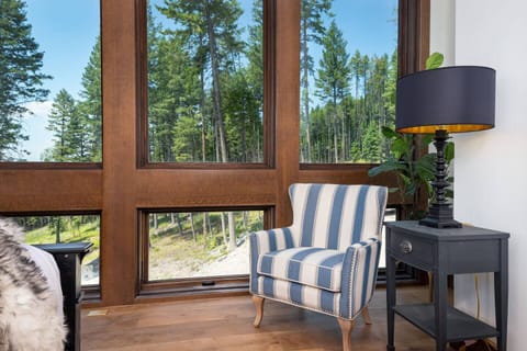 The northwest facing floor-to-ceiling windows in the top floor king ensuite, over look 12 acres of personal forest land.