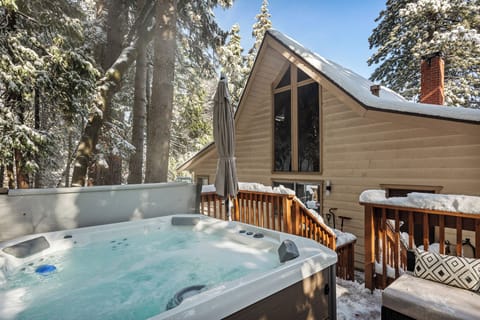 Relax in your private hot tub surrounded by towering pine trees.