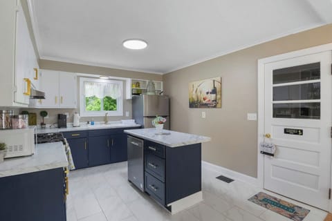 Delight in this spacious, modern kitchen featuring a large central island and sleek finishes, perfect for culinary creations and social gatherings.