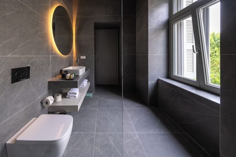 Shower, designer toiletries, hair dryer, bathrobes