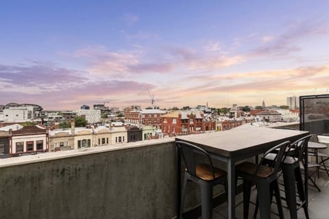 Private balcony with outdoor seating and sweeping city views