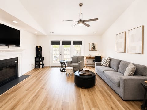 Large living room with 65” smart TV. Open floor plan. Dedicated workspace,