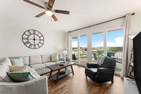 Relax in this modern living room with large windows and balcony views.