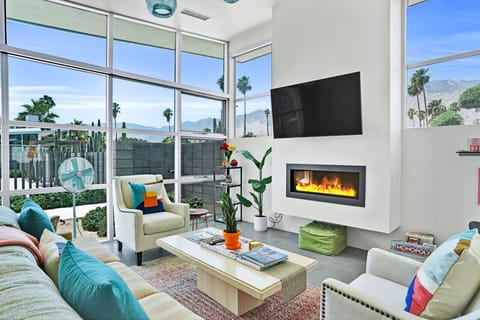 Spacious and modern living room with floor to ceiling windows, tons of natural light