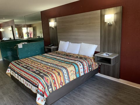 Room, 1 King Bed, Jetted Tub | Individually decorated, individually furnished, desk, iron/ironing board