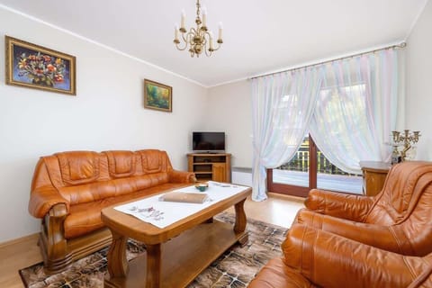 Relax in the stylish living room with a comfortable sofa and traditional decor.
