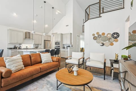 Offering the best of elegance, luxury, and cozy comfort, this living room has it all – high ceilings, a fireplace, tasteful furniture, and designer décor!