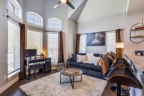 Bright living room with queen sleeper sofa, Roku TV, and workspace.