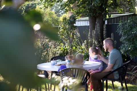 Dine outdoors under the shade of a large elm tree