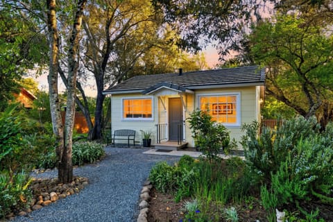 Charming exterior surrounded by vibrant flowers.
