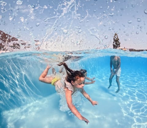Seasonal outdoor pool, open 9:00 AM to 8:00 PM, pool umbrellas