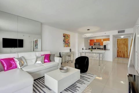 The open living room seamlessly connects to the balcony, kitchen, dining area, and dedicated workspace!