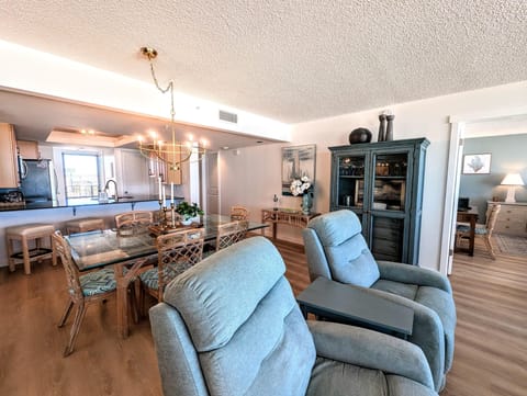 Cozy living and dining area with plush recliners and open kitchen view