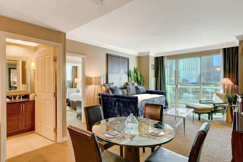 Spacious living room with dining table and another full bathroom.