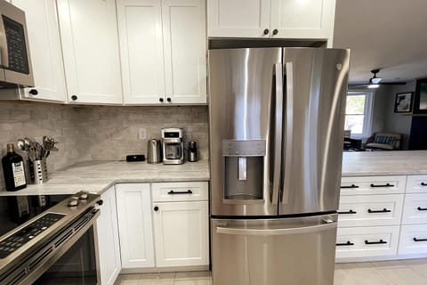 Coffee maker, grinder, and tea kettle provided.