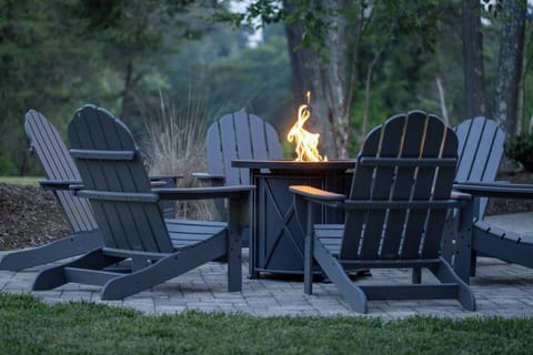 This is the real feel of our outdoor fire pit area and has enough space for 6 to enjoy while relaxing in the comfort of the adirondack outdoor chairs.
