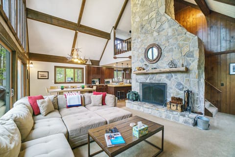 Cozy up in the living room with vaulted ceilings, a stone fireplace, and plenty of seating for your group.