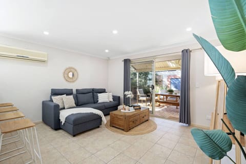 Step into this bright and inviting open-plan living space, bathed in natural light and featuring gleaming timber floors.