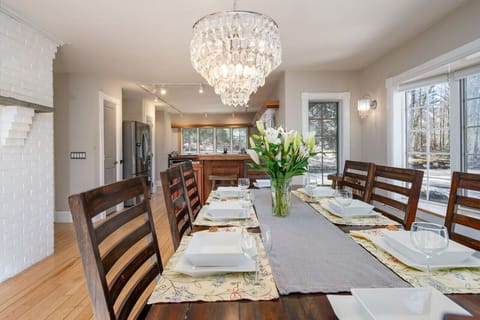 Dining table with a large window offering beautiful natural light.