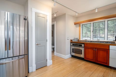 Modern kitchen featuring a refrigerator and stove for all your cooking needs.