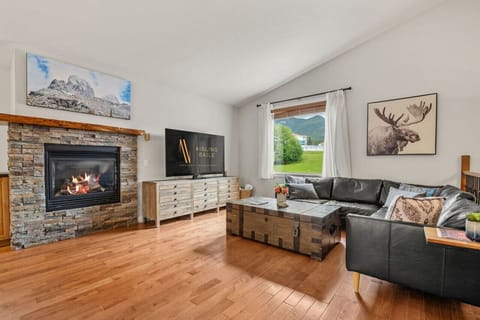 Main floor living room with a gas fireplace and a 65` Smart TV