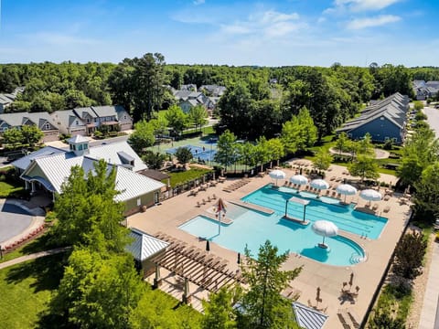 Community family pool with bathrooms, walk in area, sunken chair lounger area, no on-duty lifeguard, key fob access included with home rental