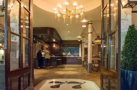 Welcoming lobby of the hotel with elegant chandeliers and a vintage aesthetic