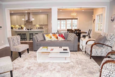 Open concept family living room with fireplace, full kitchen and dining area