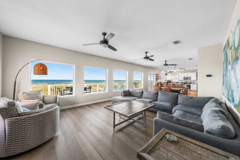 Sink into plush sofas while ocean breezes flow through your spacious living room with breathtaking sea views stretching to the horizon.