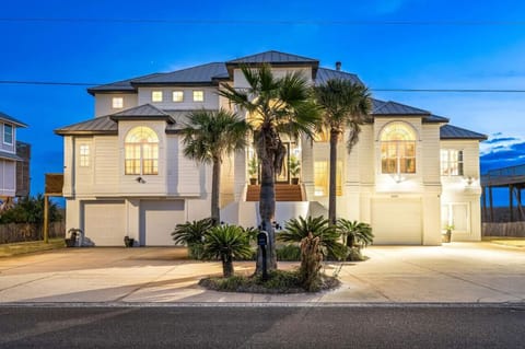 Stunning beachfront property featuring elegant architecture with tropical landscaping and coastal charm in a peaceful neighborhood setting.