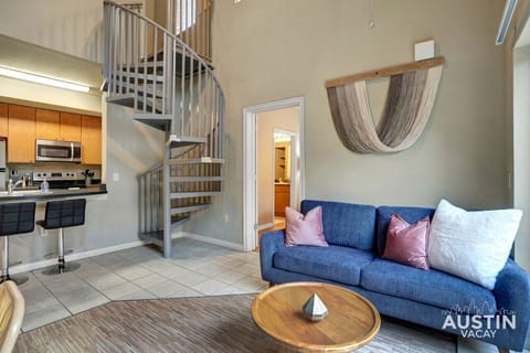 Living room in the second apartment with spiral staircase and balcony