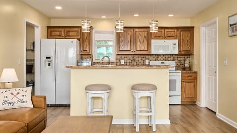 The well equipped Kitchen is open to the Living Room upstairs. 
