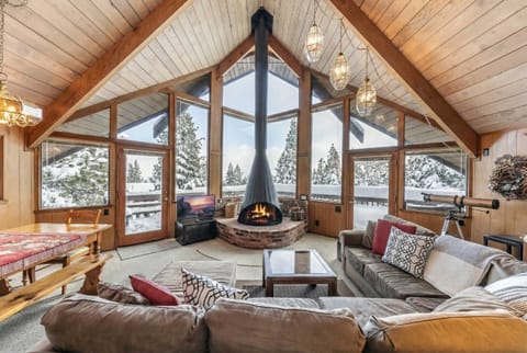 Living room: Wood fireplace, Smart TV, large l-shaped couch, access to deck