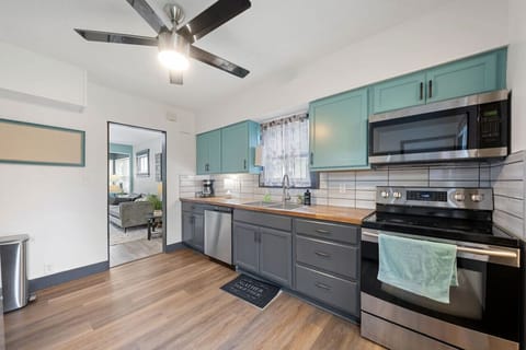 Bright, modern kitchen with everything you need — from coffee to cookware — plus bar seating for two.
