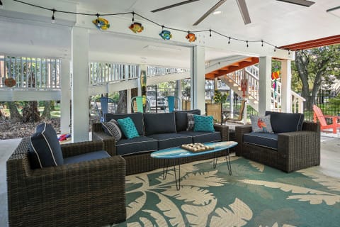 WOW!   Check out this great outdoor space, fully shaded with big screen TV, ceiling fan, and bar area!   So much fun to be had in and around this lovely property.  The owners really went all out.