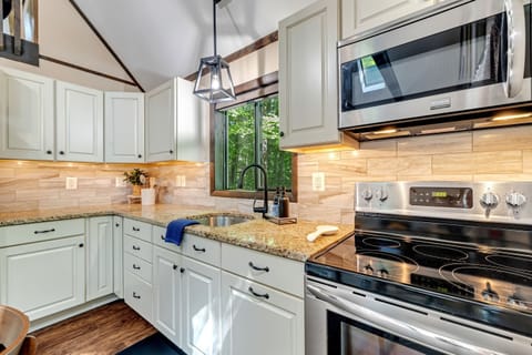 Modern kitchen with stainless steel appliances and granite countertops