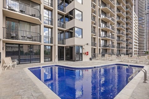 Refresh by the pool surrounded by sleek city towers.