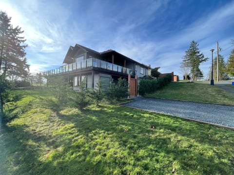Main house above and Suite Seascape below with suites private pebbled parking.