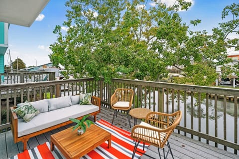 Unwind on the terrace with cozy, private lounge seating and stunning canal views