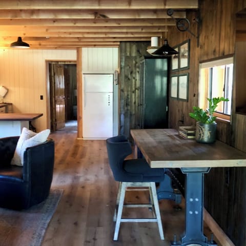 The black leather club chair swivels for all the best views; TV, fire, & kitchen