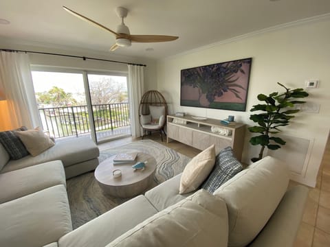 Living area with roomy and comfortable sectional and sliders to balcony