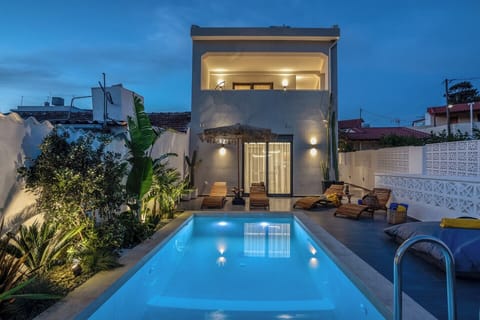 The amazing villa with the pool in the evening.