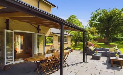Private garden terrace with outdoor dining and seating, perfect for al fresco meals or morning coffee with views at The Timbers.
