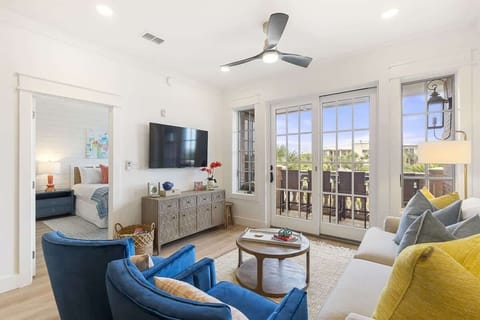 - Gather in this stylish living room with plush seating, smart TV, and warm coastal accents - French doors open to a private balcony with peaceful views and fresh air - Sunny, comfortable hub for conversation, coffee, or cozy nights in
