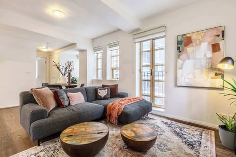 Living Room at Tribeca: Stylish living room with a modern sofa, warm tones, and natural light