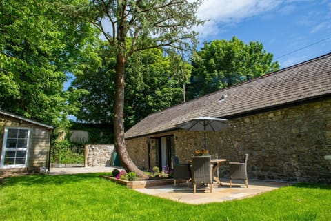 Patio doors leading onto furnished patio and lawn area