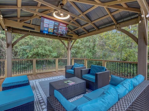 Enjoy movie nights with outdoor TV, comfy seating & ambient lighting.